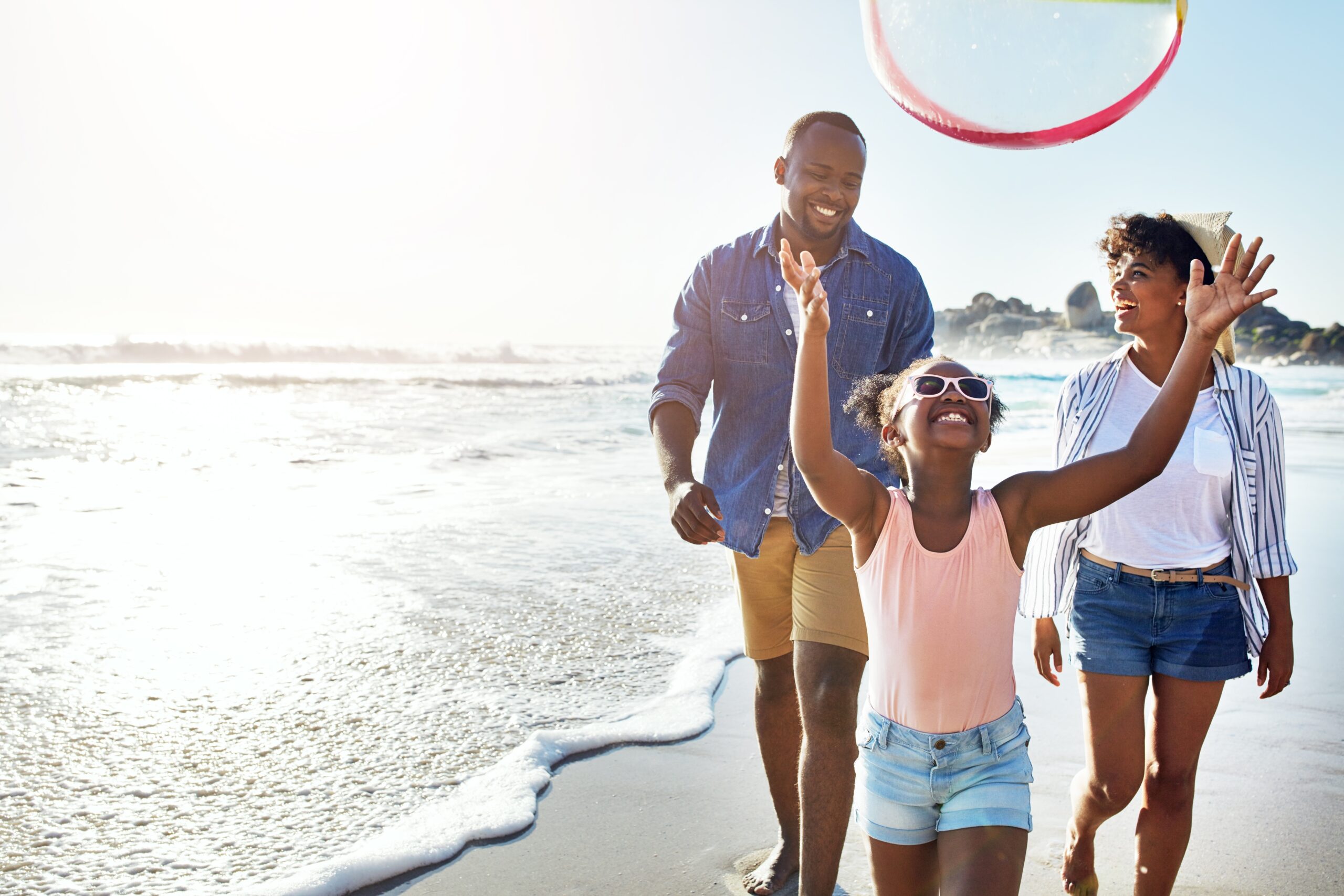 Black,Family,,Parents,And,Daughter,With,Ball,On,Beach,For